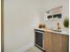 Stylish wet bar with marble countertop, wine cooler, and gold faucet at 9217 Hidden Bay Ln, Orlando, FL 32819