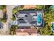 Aerial showcasing a home with a unique roofline and a large, screened-in pool at 9217 Hidden Bay Ln, Orlando, FL 32819
