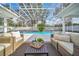 Relaxing poolside patio with covered seating and plants at 9217 Hidden Bay Ln, Orlando, FL 32819