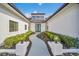 Elegant entryway with a winding walkway and landscaping at 9217 Hidden Bay Ln, Orlando, FL 32819