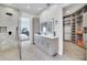 Bathroom with walk-in shower, marble, and large closet at 9217 Hidden Bay Ln, Orlando, FL 32819