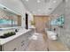 Modern bathroom with a freestanding tub and marble tile at 9217 Hidden Bay Ln, Orlando, FL 32819