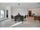 Modern dining area with wood table, stylish chairs, and adjacent kitchen at 9217 Hidden Bay Ln, Orlando, FL 32819