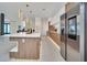 Modern kitchen with stainless steel appliances and light wood cabinets at 9217 Hidden Bay Ln, Orlando, FL 32819