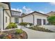 Modern home exterior with a walkway, landscaping, and attached two-car garage at 9217 Hidden Bay Ln, Orlando, FL 32819