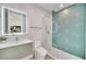 Modern bathroom with teal geometric tile and glass shower at 9217 Hidden Bay Ln, Orlando, FL 32819