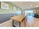 Long wooden dining table with seating for eight, and access to kitchen and living room at 2411 Luxor Dr, Kissimmee, FL 34747