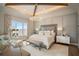 Spacious primary bedroom with water views, king-size bed, and sitting area at 4018 Grande Brick Loop # 10, Orlando, FL 32837