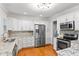Modern kitchen with stainless steel appliances and granite countertops at 1310 Aloma Ave, Winter Park, FL 32789