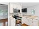 Kitchen with white cabinets, granite countertops, and stainless steel appliances at 1310 Aloma Ave, Winter Park, FL 32789