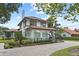 Two-story home showcasing terracotta tile roof and landscaping at 1310 Aloma Ave, Winter Park, FL 32789