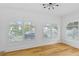 Sunroom with hardwood floors, arched windows, and plantation shutters at 1310 Aloma Ave, Winter Park, FL 32789