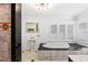 Elegant bathroom with a pedestal sink, a soaking tub, and marble flooring at 1310 Aloma Ave, Winter Park, FL 32789