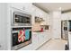 Modern kitchen with white cabinets, stainless steel appliances, and quartz countertops at 6030 Arbor Watch Loop, Orlando, FL 32829