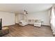 Bright living room featuring an L-shaped sofa and hardwood floors at 6030 Arbor Watch Loop, Orlando, FL 32829