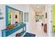 Light and airy entryway with teal console table and mirror at 6030 Arbor Watch Loop, Orlando, FL 32829