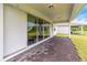 Covered patio with brick pavers and sliding glass doors leading to the interior at 6030 Arbor Watch Loop, Orlando, FL 32829