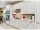 Modern kitchen with white cabinets, quartz countertops, and stainless steel appliances at 6030 Arbor Watch Loop, Orlando, FL 32829