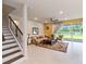 Modern staircase with metal railing leading to the upper level at 6030 Arbor Watch Loop, Orlando, FL 32829