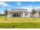 House exterior showcasing a back patio with solar panels at 6030 Arbor Watch Loop, Orlando, FL 32829