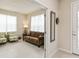 Bright living room with brown sofa and armchairs at 6030 Arbor Watch Loop, Orlando, FL 32829