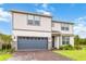 Two-story house with a gray garage door and landscaping at 6030 Arbor Watch Loop, Orlando, FL 32829