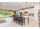 Open concept kitchen with island, stainless steel appliances, and lake view at 6030 Arbor Watch Loop, Orlando, FL 32829