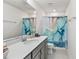 Clean bathroom with shower/tub combo and gray vanity at 6030 Arbor Watch Loop, Orlando, FL 32829