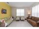 Cozy living room featuring a brown sofa and armchairs at 6030 Arbor Watch Loop, Orlando, FL 32829