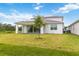 House exterior showcasing a back patio with solar panels at 6030 Arbor Watch Loop, Orlando, FL 32829