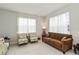 Relaxing living room with brown sofa and armchairs at 6030 Arbor Watch Loop, Orlando, FL 32829