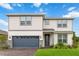 Two-story home with gray garage door and landscaping at 6030 Arbor Watch Loop, Orlando, FL 32829
