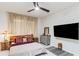 Spacious main bedroom with a large TV, ceiling fan and ensuite bathroom at 6030 Arbor Watch Loop, Orlando, FL 32829