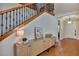 Elegant entryway with hardwood floors, storage cabinet, and wooden staircase at 9149 Outlook Rock Trl, Windermere, FL 34786
