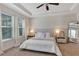 Bright and airy Primary bedroom with a king-size bed, and ceiling fan at 9149 Outlook Rock Trl, Windermere, FL 34786