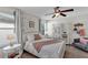 Charming bedroom with a cozy bed, window seating and a ceiling fan at 9149 Outlook Rock Trl, Windermere, FL 34786