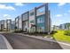 Modern townhome community with teal and gray buildings at 7740 Sandy Ridge Dr # 132, Reunion, FL 34747