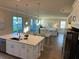 Open concept kitchen with island, stainless steel appliances, and view to living room at 3219 Legends Preserve Dr, Daytona Beach, FL 32124