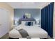Primary bedroom with a king-size bed and blue accents at 2433 Caravelle Cir, Kissimmee, FL 34746