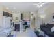Open floor plan with kitchen island, living room, and dining area at 2433 Caravelle Cir, Kissimmee, FL 34746