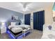 Primary bedroom with a king-size bed and blue accents at 2433 Caravelle Cir, Kissimmee, FL 34746