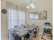 Bright dining room with table set for six and large mirror at 2433 Caravelle Cir, Kissimmee, FL 34746