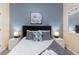 Bedroom with queen-size bed and gray accent wall at 2433 Caravelle Cir, Kissimmee, FL 34746