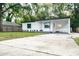 Front view of a charming house with a carport and well-maintained lawn at 635 Maitland Ave, Altamonte Springs, FL 32701