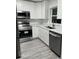 Modern kitchen with stainless steel appliances and white cabinets at 635 Maitland Ave, Altamonte Springs, FL 32701