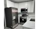 Renovated kitchen, featuring stainless steel appliances and white cabinets at 635 Maitland Ave, Altamonte Springs, FL 32701