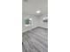 Bright living room with gray vinyl flooring and large window at 635 Maitland Ave, Altamonte Springs, FL 32701