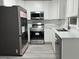 Modern kitchen with stainless steel appliances and white shaker cabinets at 635 Maitland Ave, Altamonte Springs, FL 32701