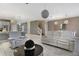 Open living room and kitchen with white sofas and modern light fixtures at 8911 Stinger Dr, Champions Gate, FL 33896