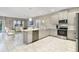 Modern kitchen with gray cabinets, stainless steel appliances, and an island at 8911 Stinger Dr, Champions Gate, FL 33896